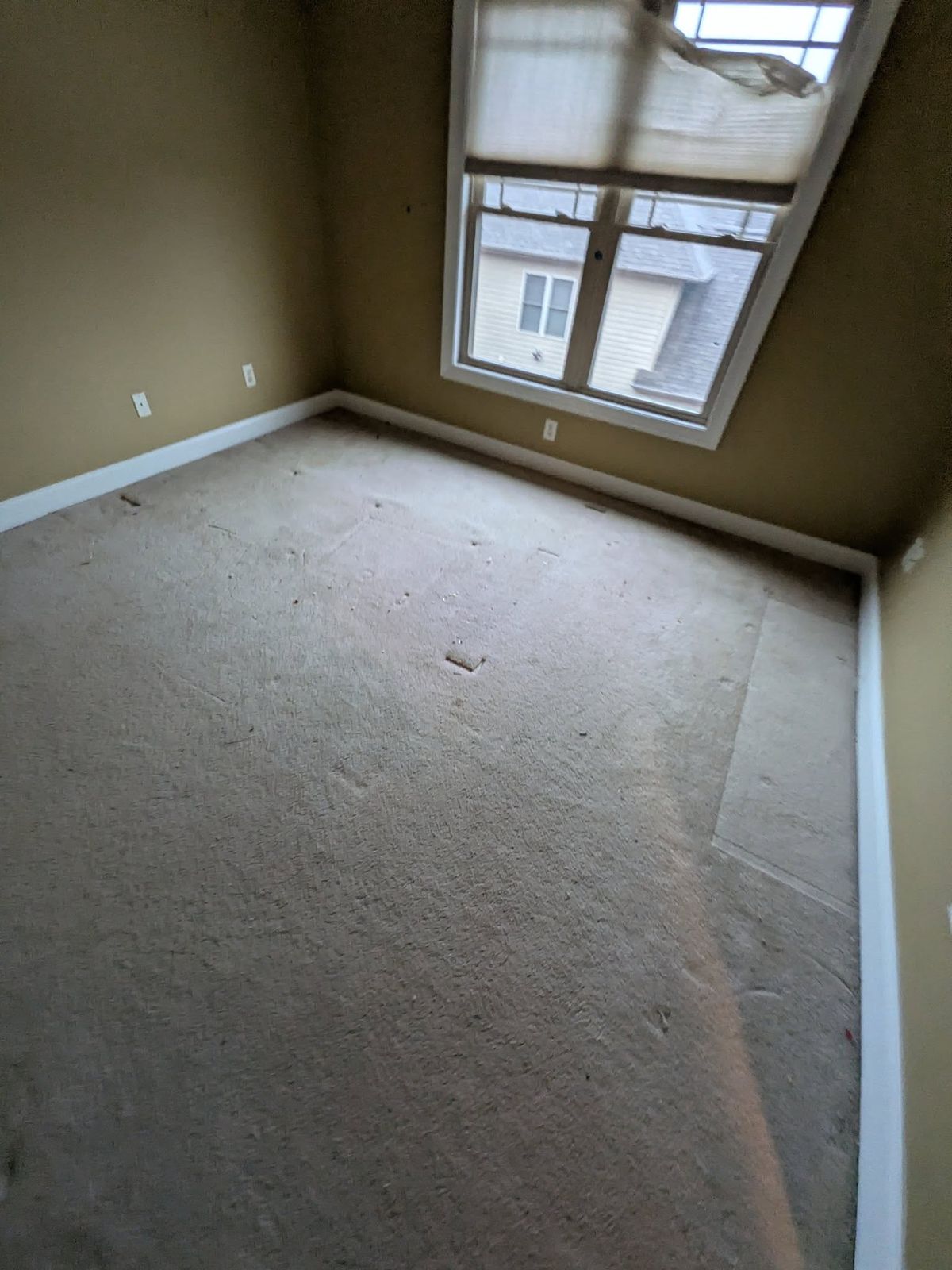 Bedroom with worn carpet before new flooring