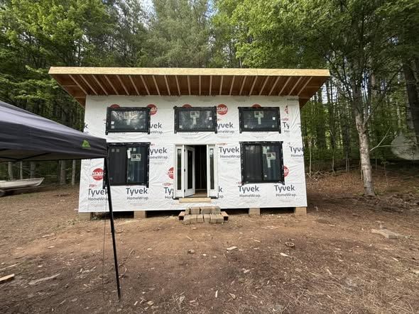 Front of a finished cabin shell with windows installed