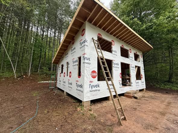 Cabin with housewrap and window openings