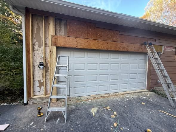 Garage front with rotted siding and trim torn off