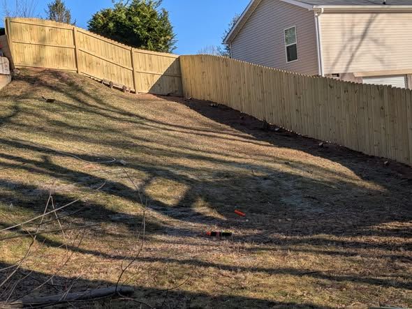 Privacy fence stepped along a sloped yard