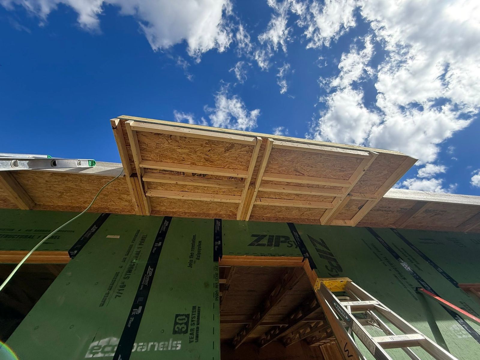 Roof overhang framing against a blue sky