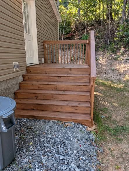 New stained wood entry stairs with railing